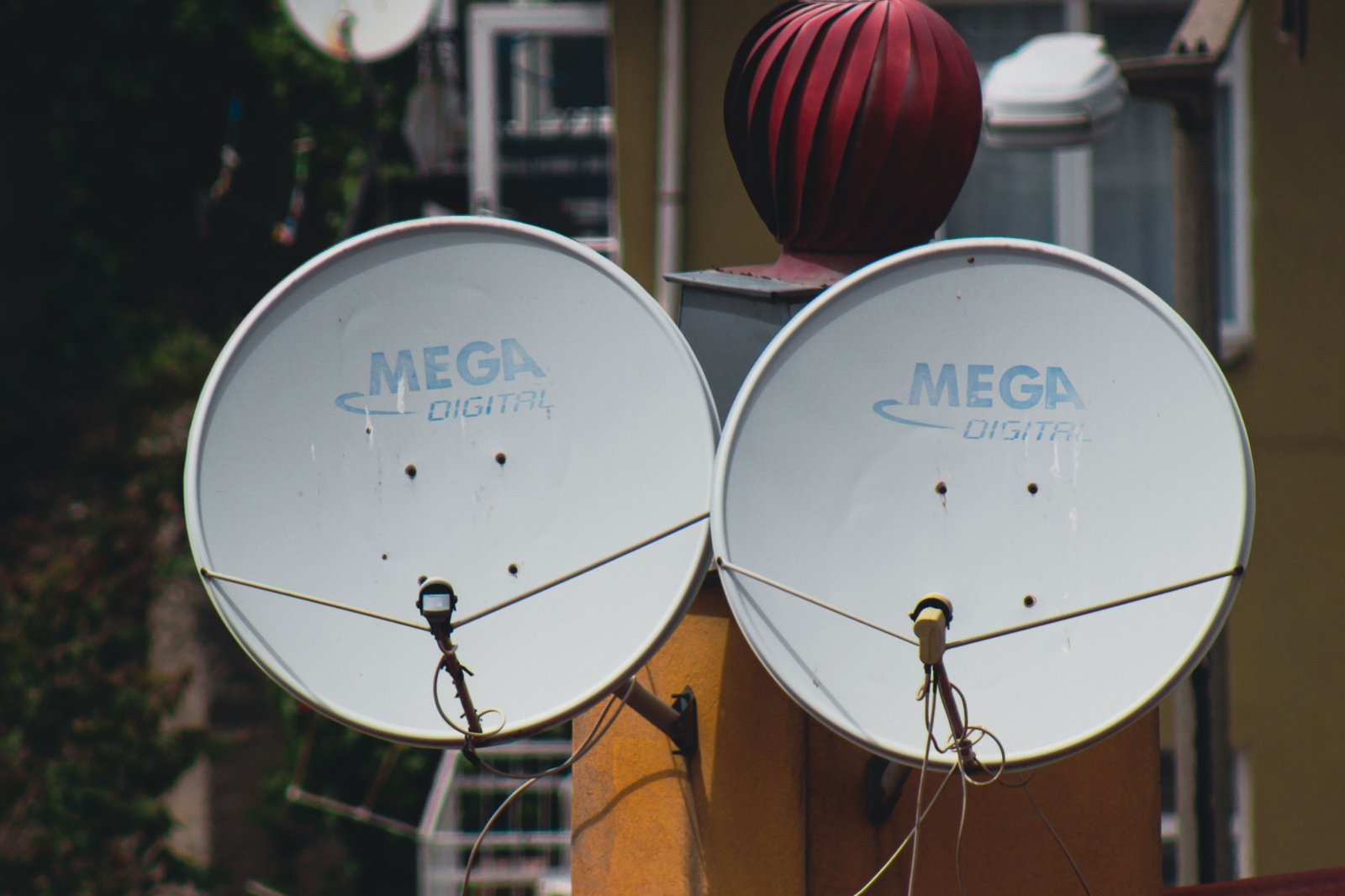 Rooftop satellite dish installation against open sky